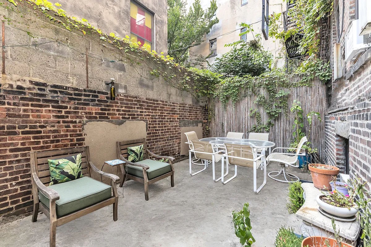 a backyard of a house with outdoor seating