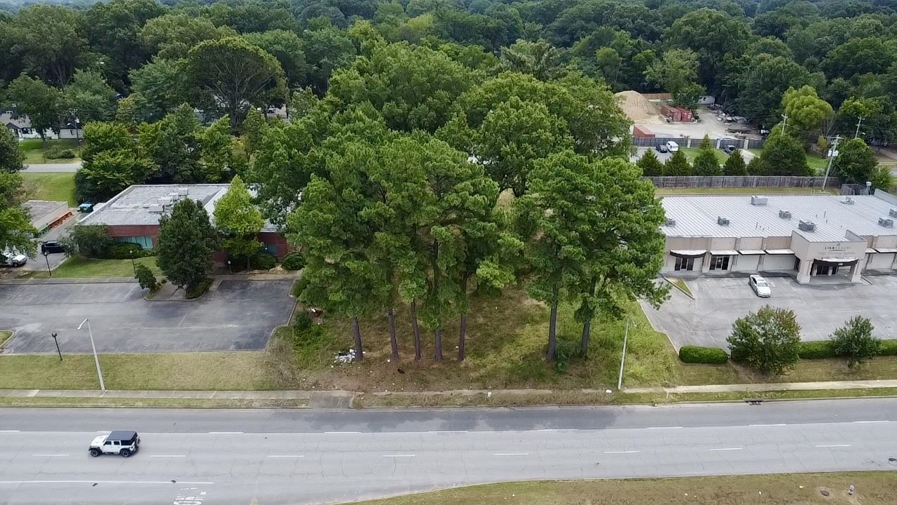 an aerial view of a house with a yard and lake view