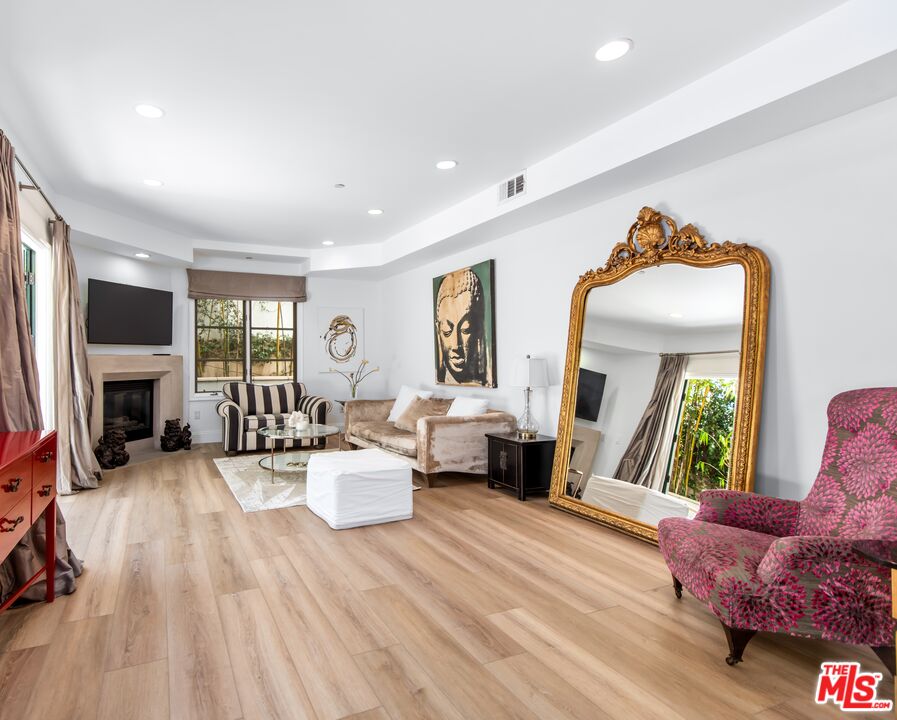 a living room with fireplace furniture and a wooden floor