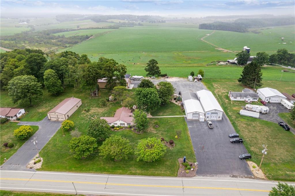 an aerial view of a houses with yard