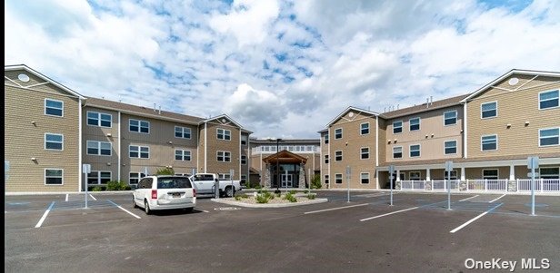 a view of building with car parked