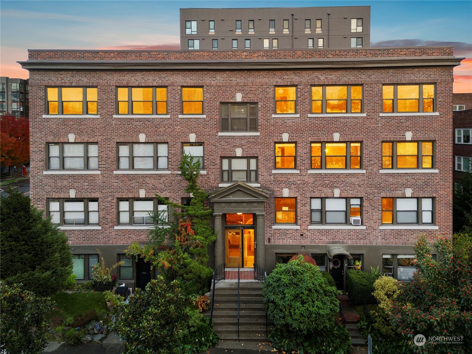 a front view of a residential apartment building with a yard