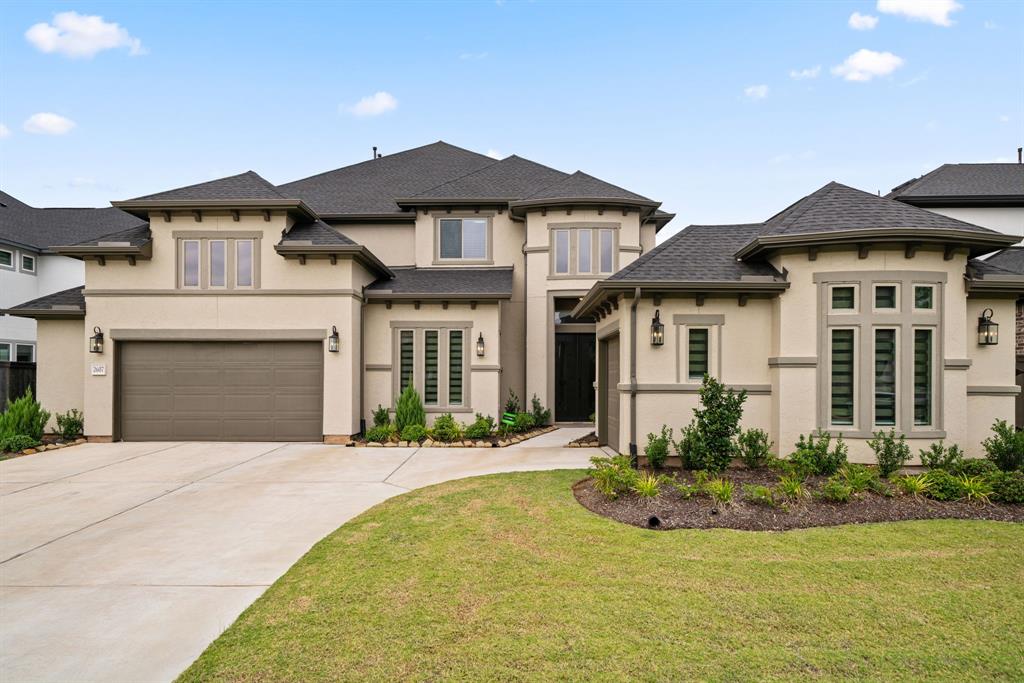 a front view of a house with a yard and garage