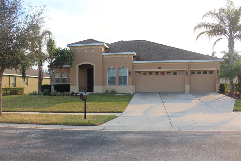 a front view of a house with a yard and garage