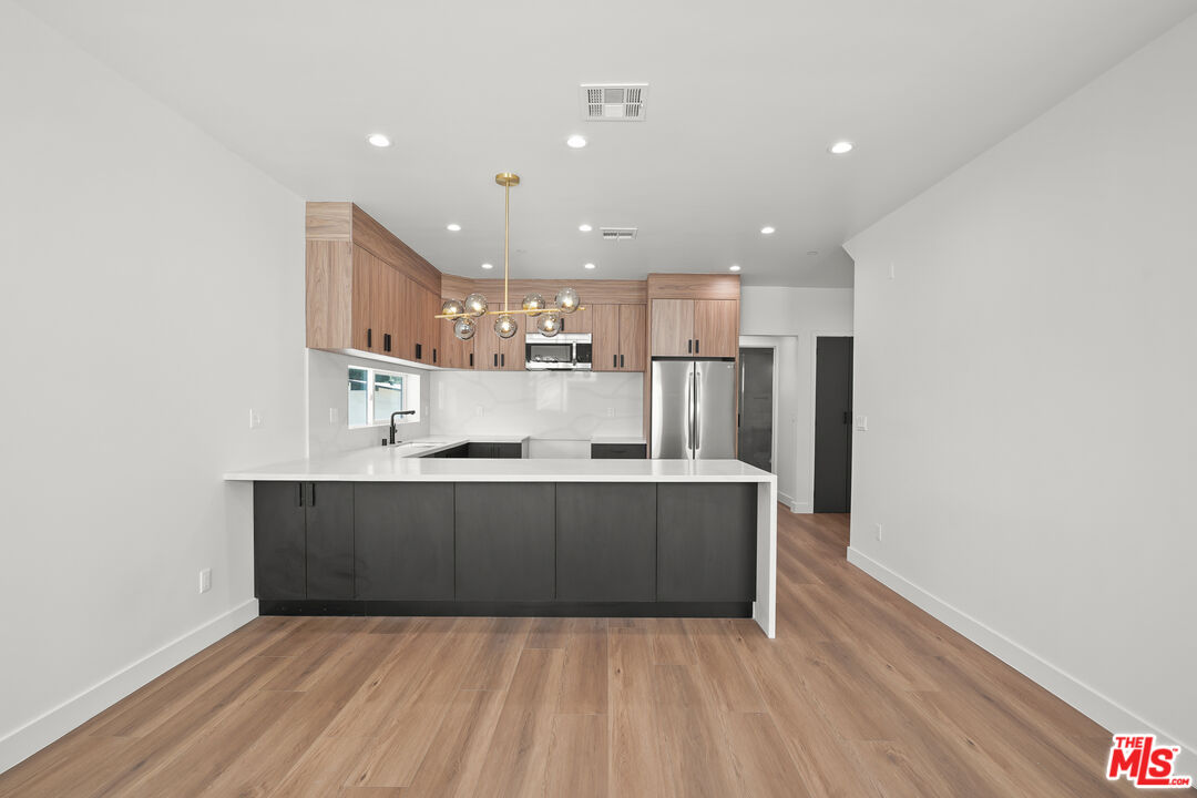 a view of kitchen with wooden floor