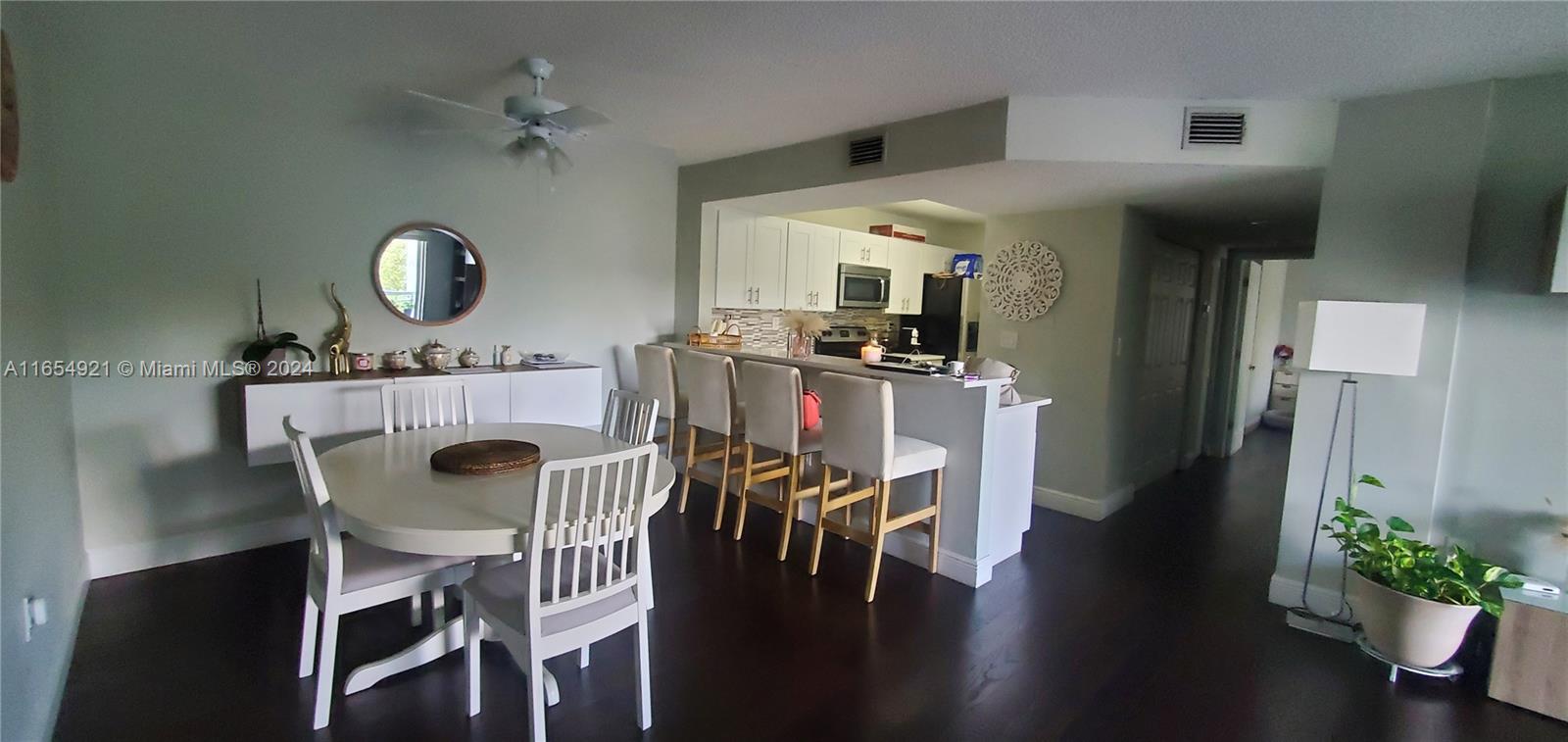 a view of a dining room with furniture wooden floor and chandelier