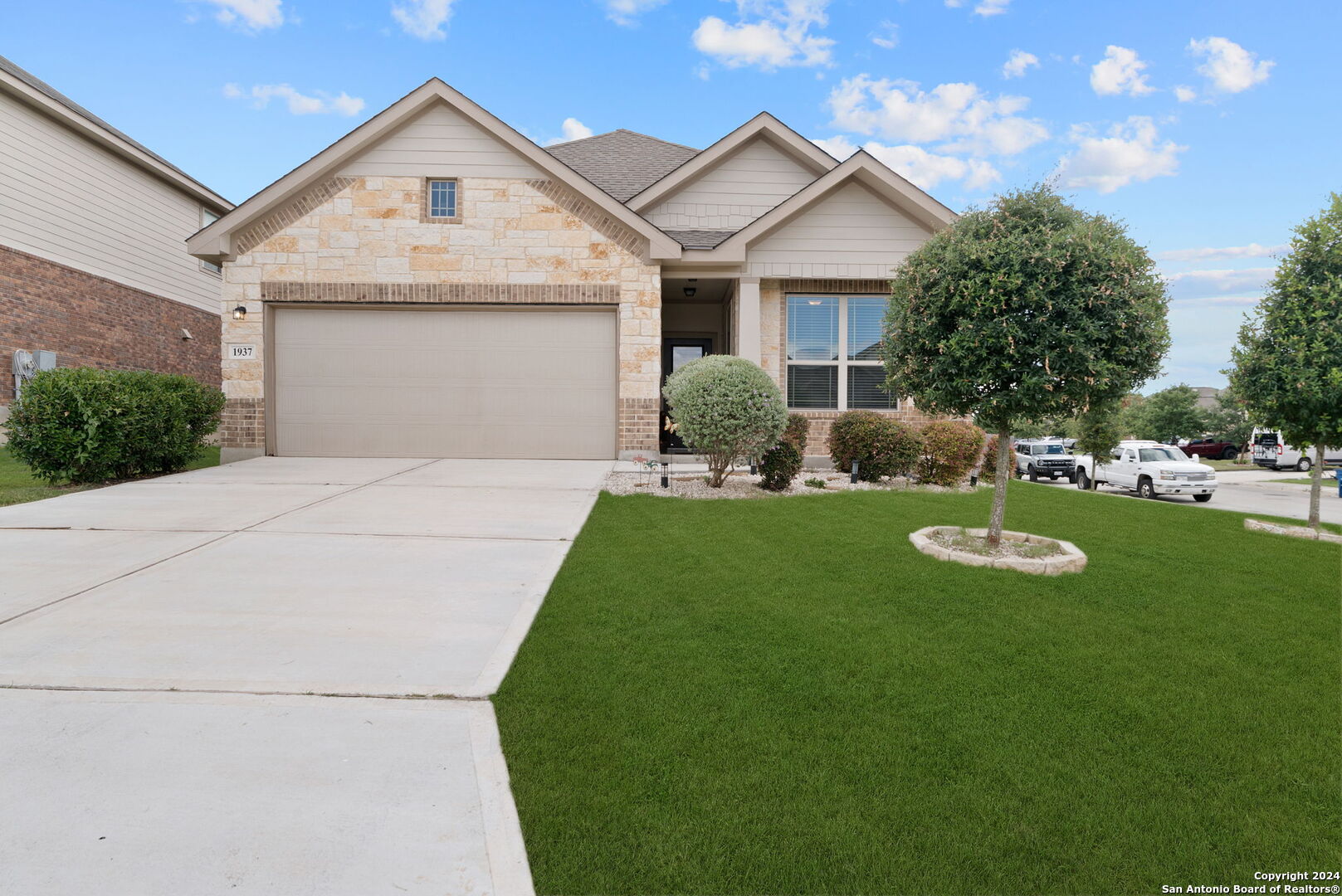 a front view of a house with a yard and garage