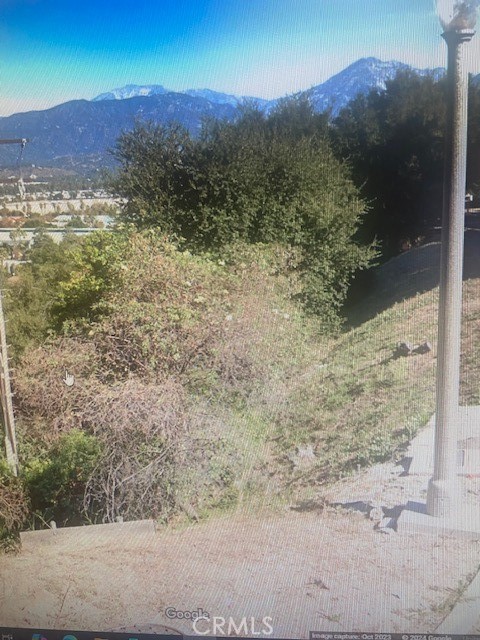 a view of a yard with mountains in the background