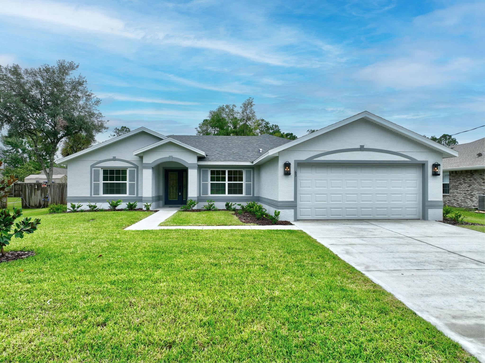 a front view of house with yard and green space