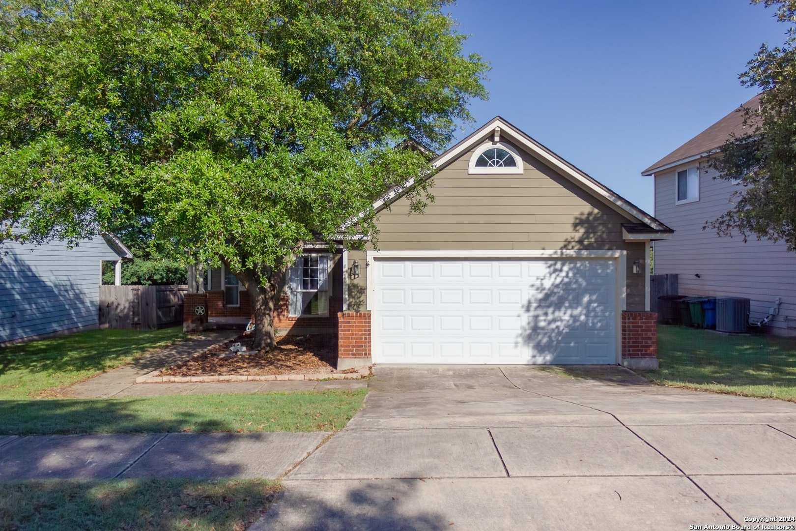 a view of a house with yard and a garage