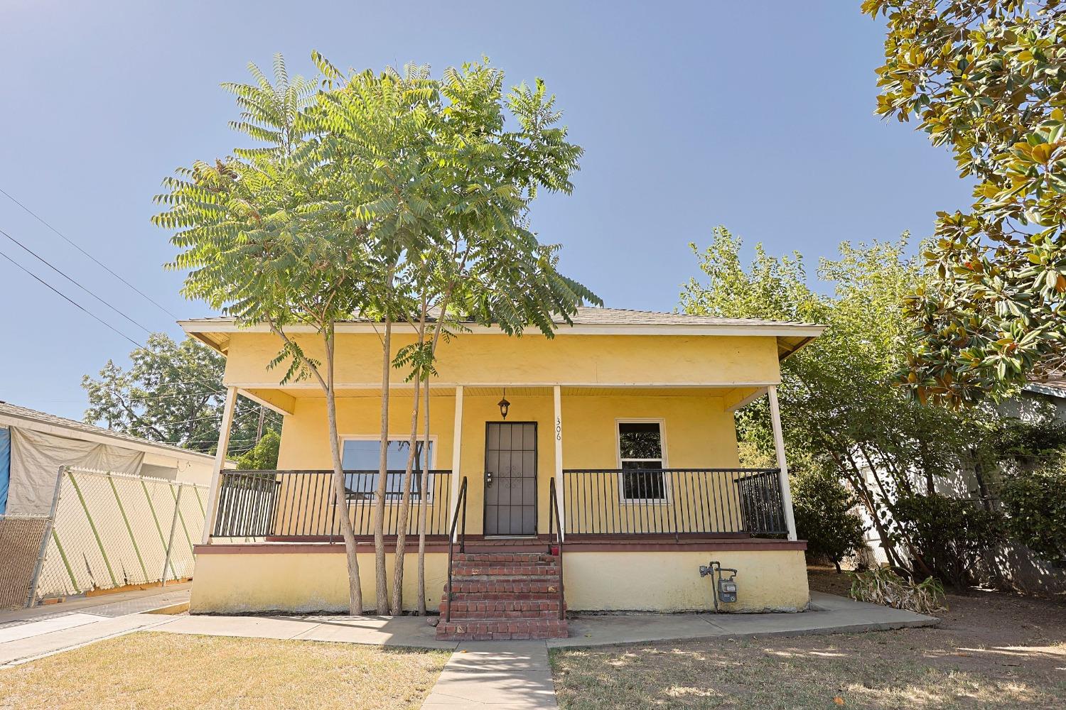 a front view of a house with a garden