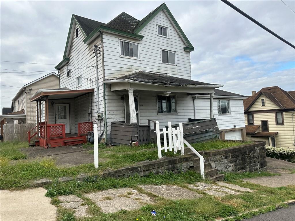 a front view of a house with a yard table and chairs