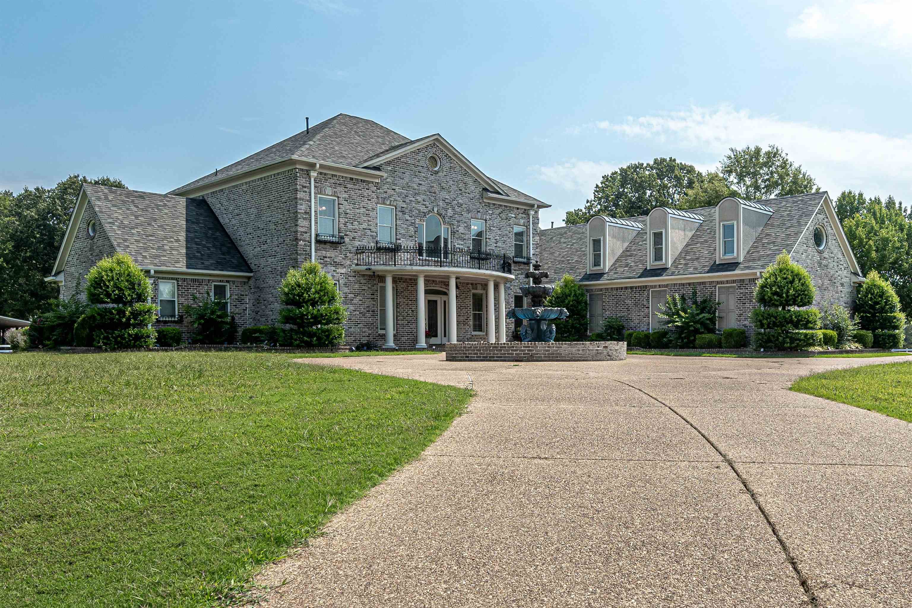 a front view of house with yard and green space