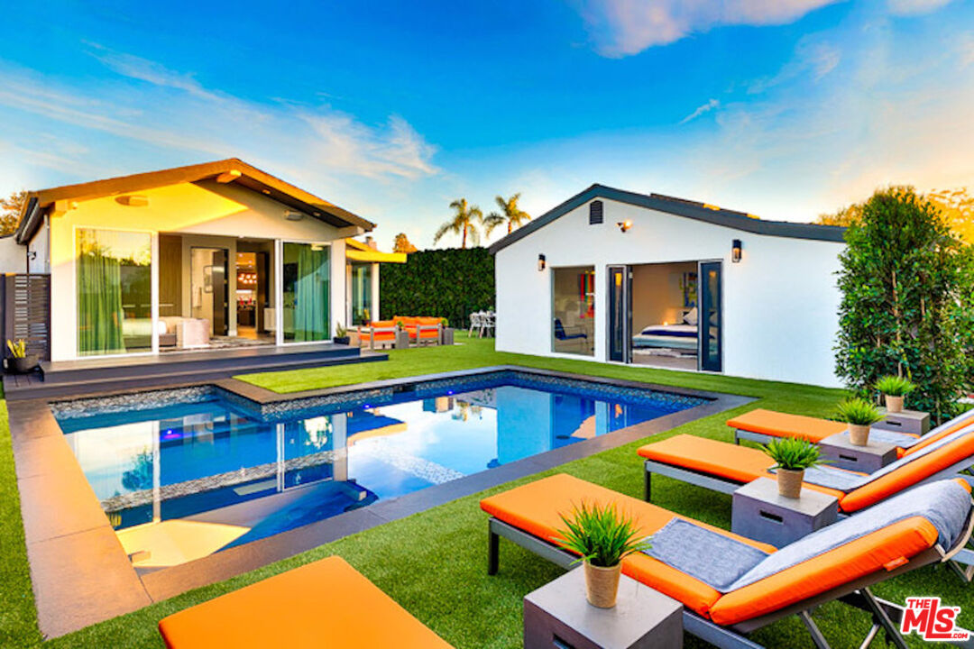 a front view of house with yard and swimming pool