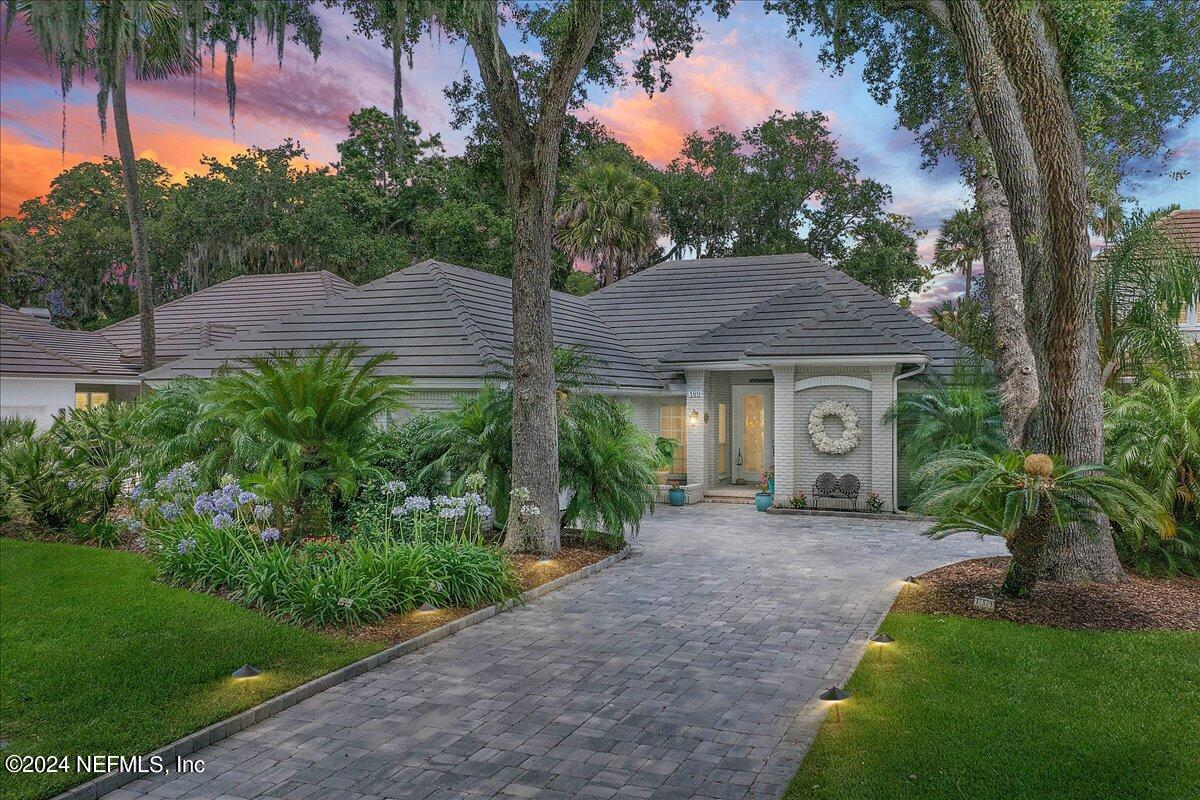 a front view of a house with a garden