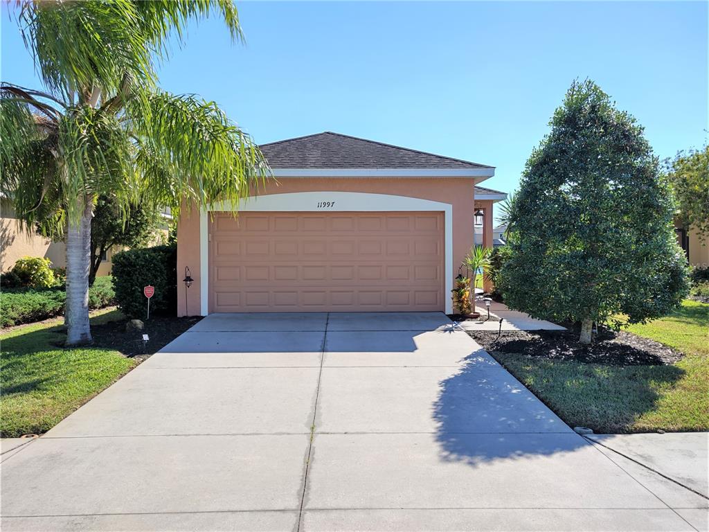 a front view of a house with a yard and garage