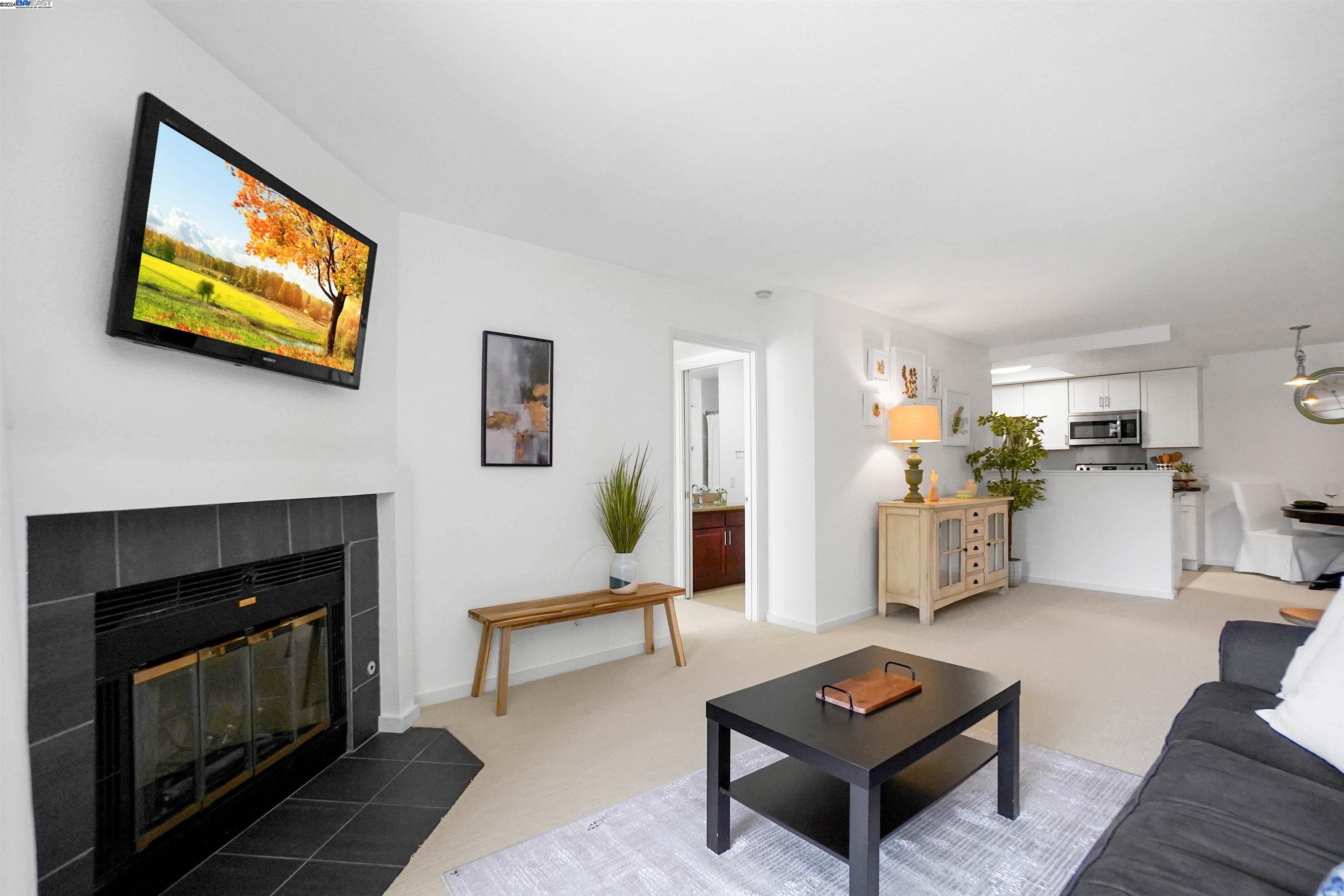 a living room with furniture a rug and a fireplace