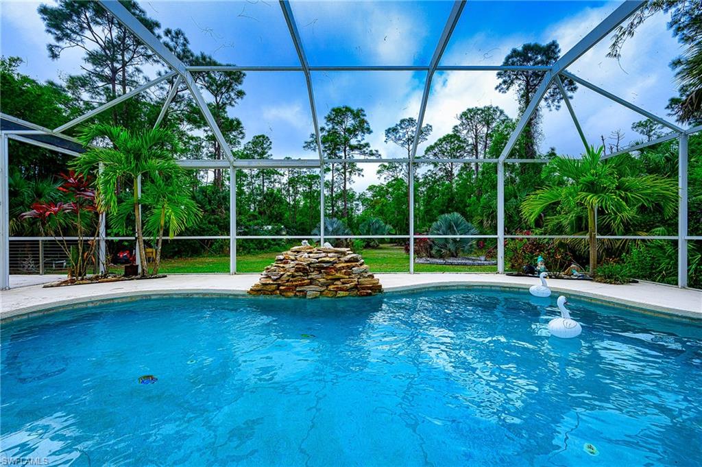 View of swimming pool featuring screen enclosure