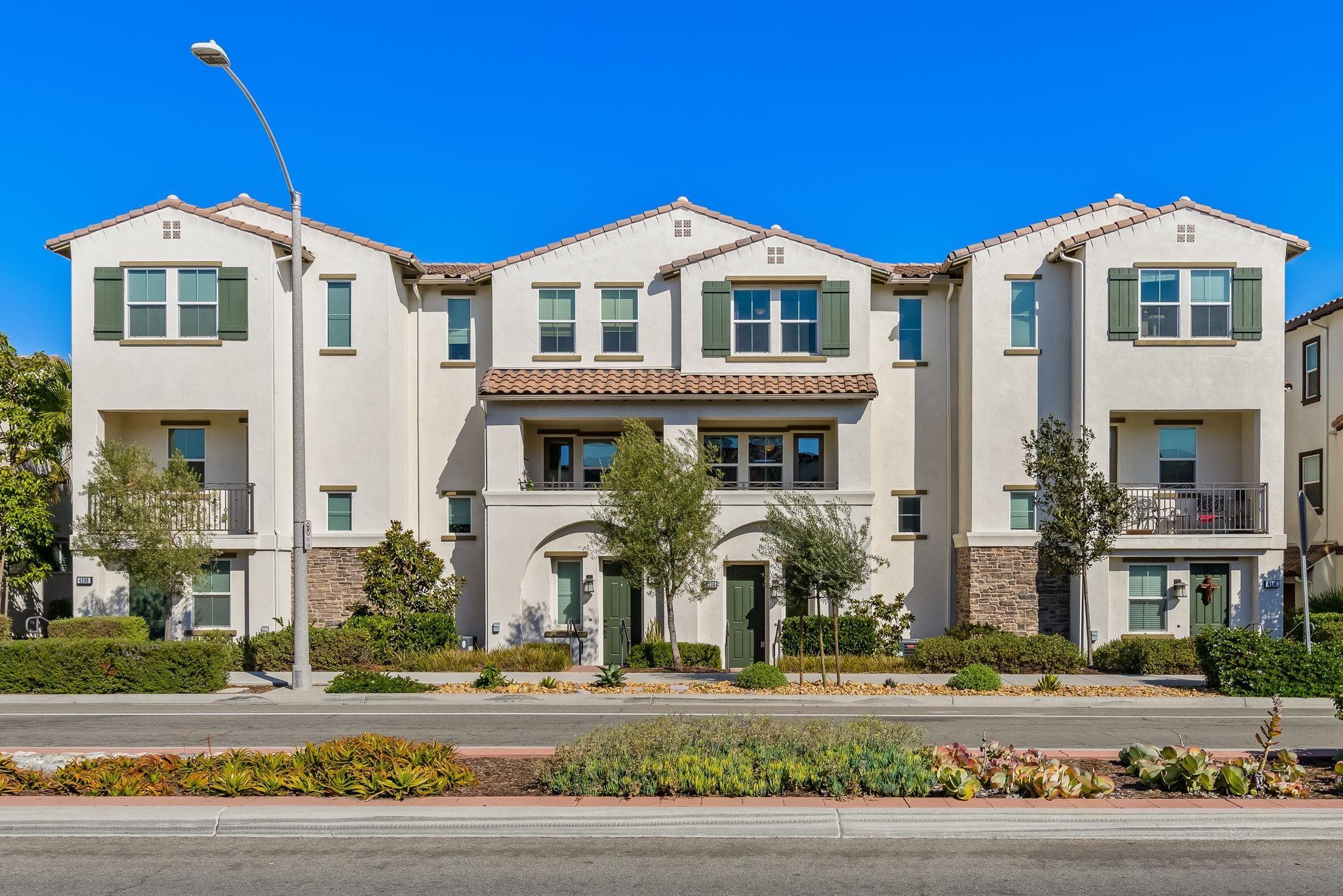 a front view of a residential apartment building with a yard