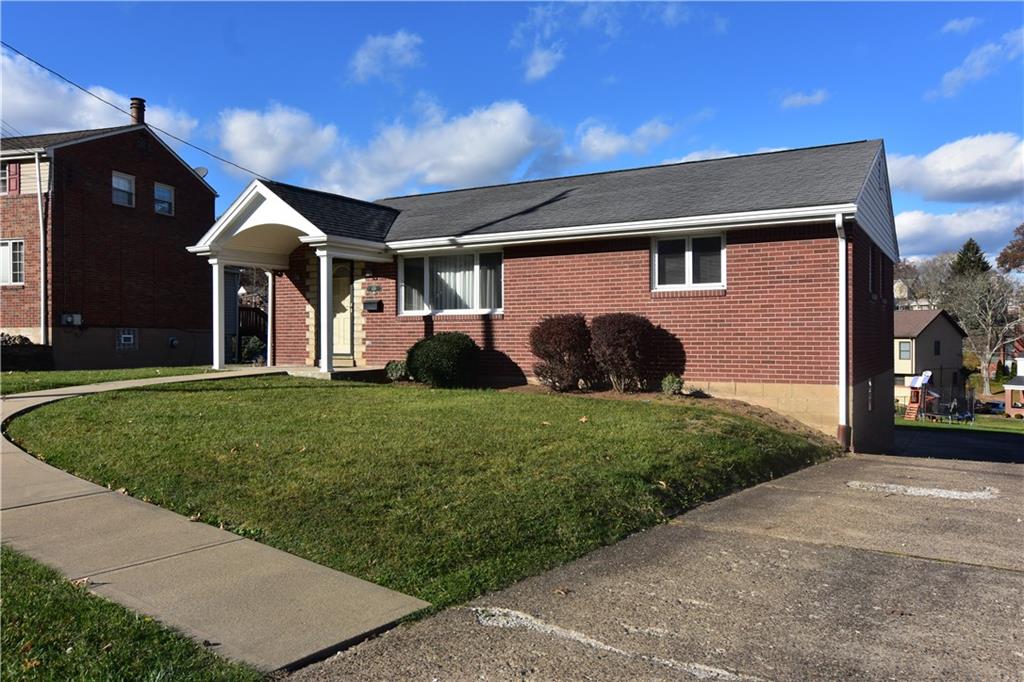 a front view of a house with a yard