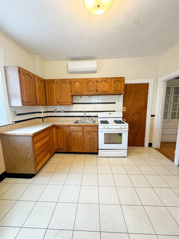 a kitchen with stainless steel appliances a stove a sink and a microwave