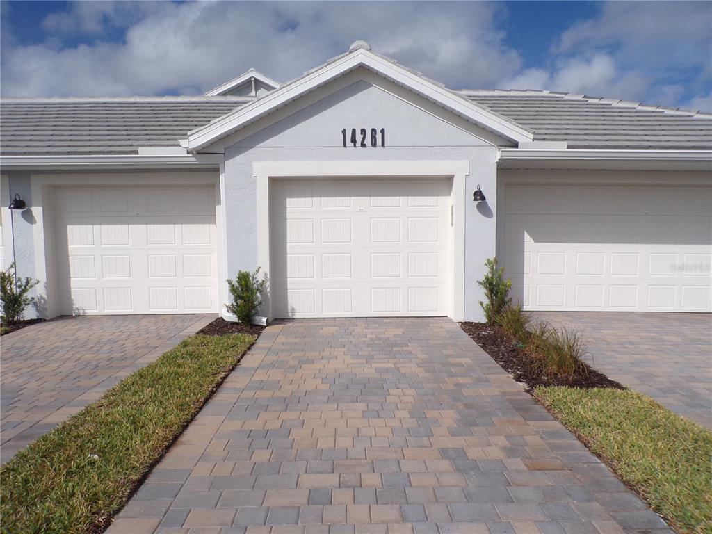 a view of a parking space in front of a house