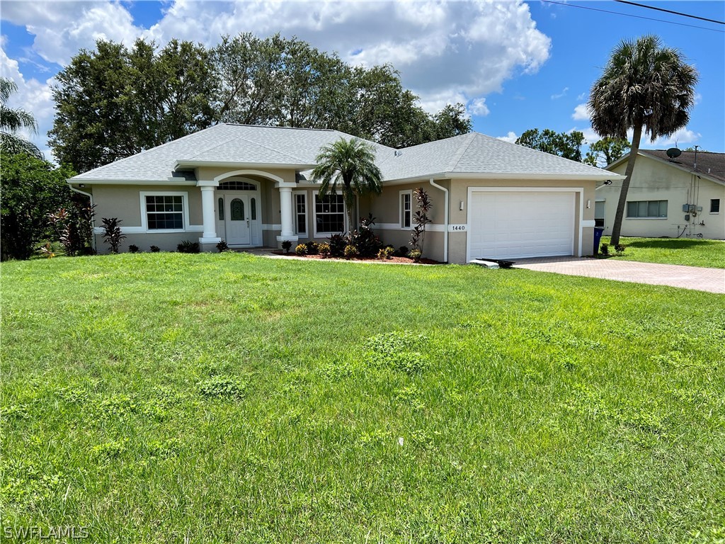 a front view of a house with garden