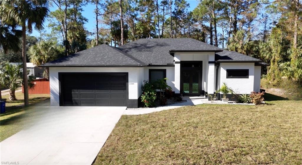 a front view of a house with a yard and garage