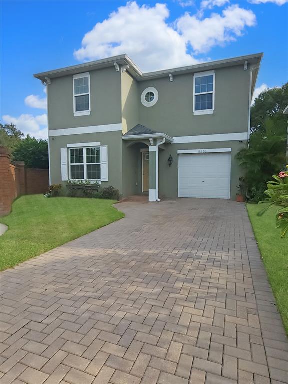 a front view of a house with a yard and a garage