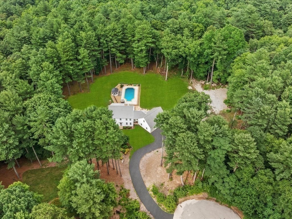 an aerial view of a house with a yard