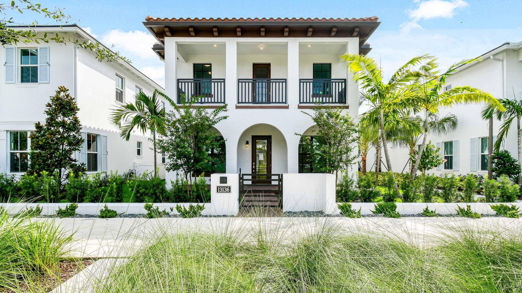 a front view of a house with a garden