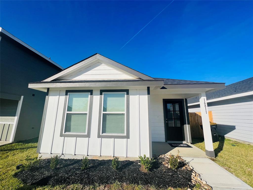 Charming single-story home with a modern exterior, featuring two front windows and a cozy porch. The well-maintained landscape adds to its curb appeal. Perfect for tenants seeking a welcoming neighborhood.