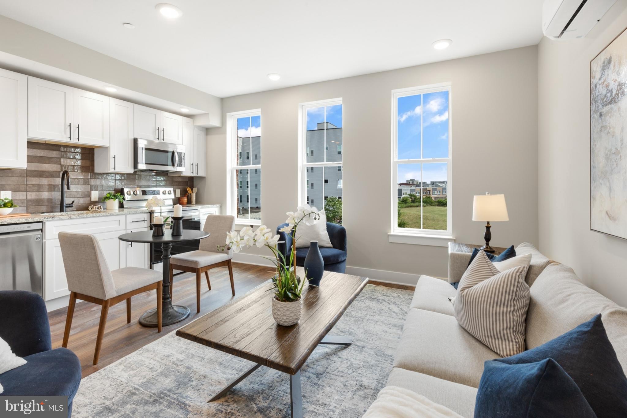 a living room with furniture wooden floor and a table