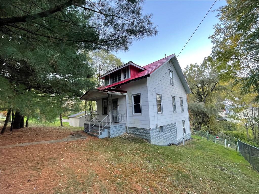 a view of house with backyard and garden