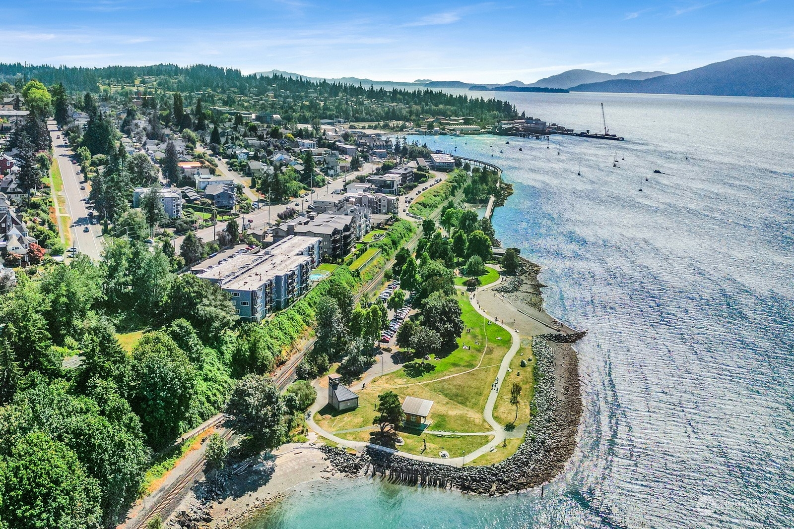 an aerial view of a house with a yard and lake view