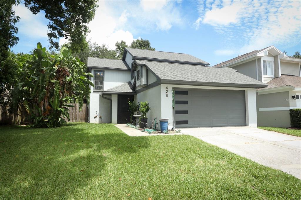 a front view of a house with a yard and garage