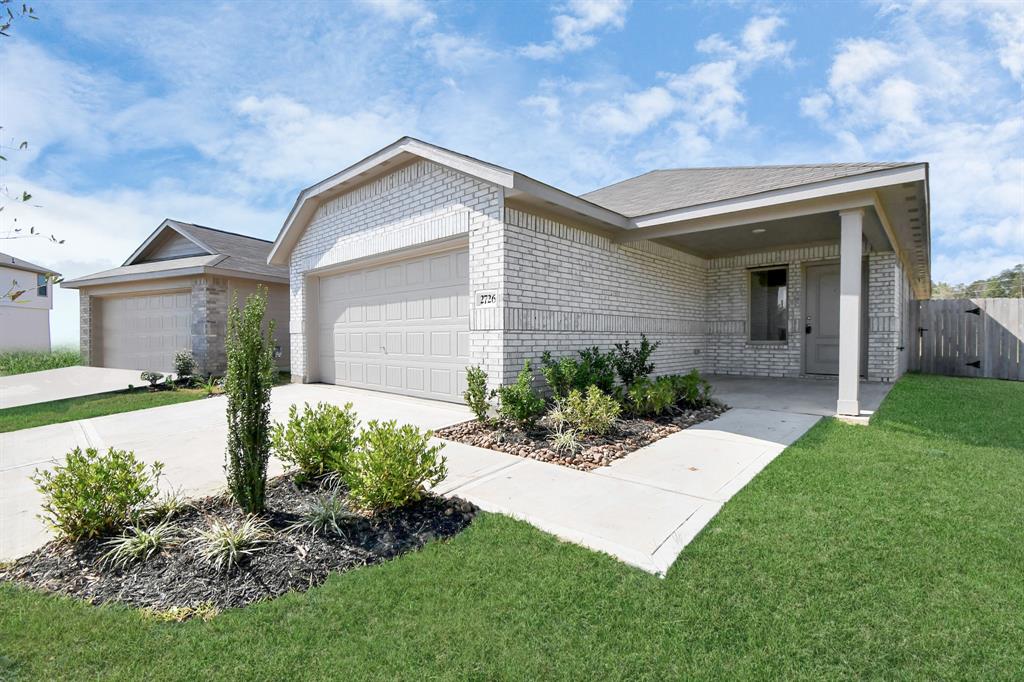 a view of a house with a yard and plants