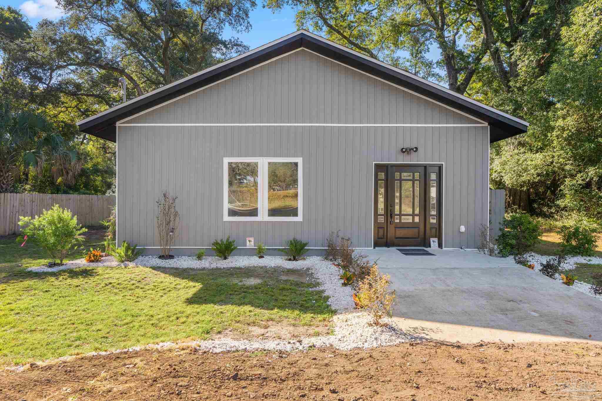 a view of backyard of house with outdoor seating