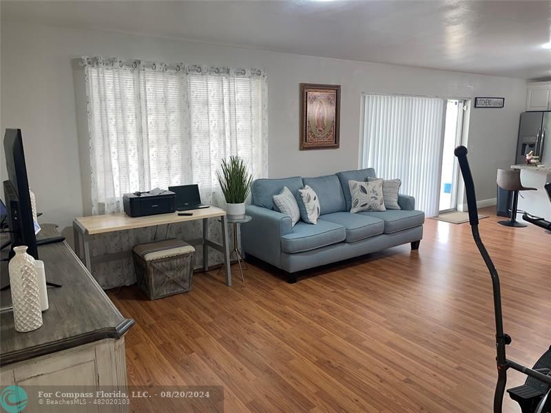 a living room with furniture and large windows