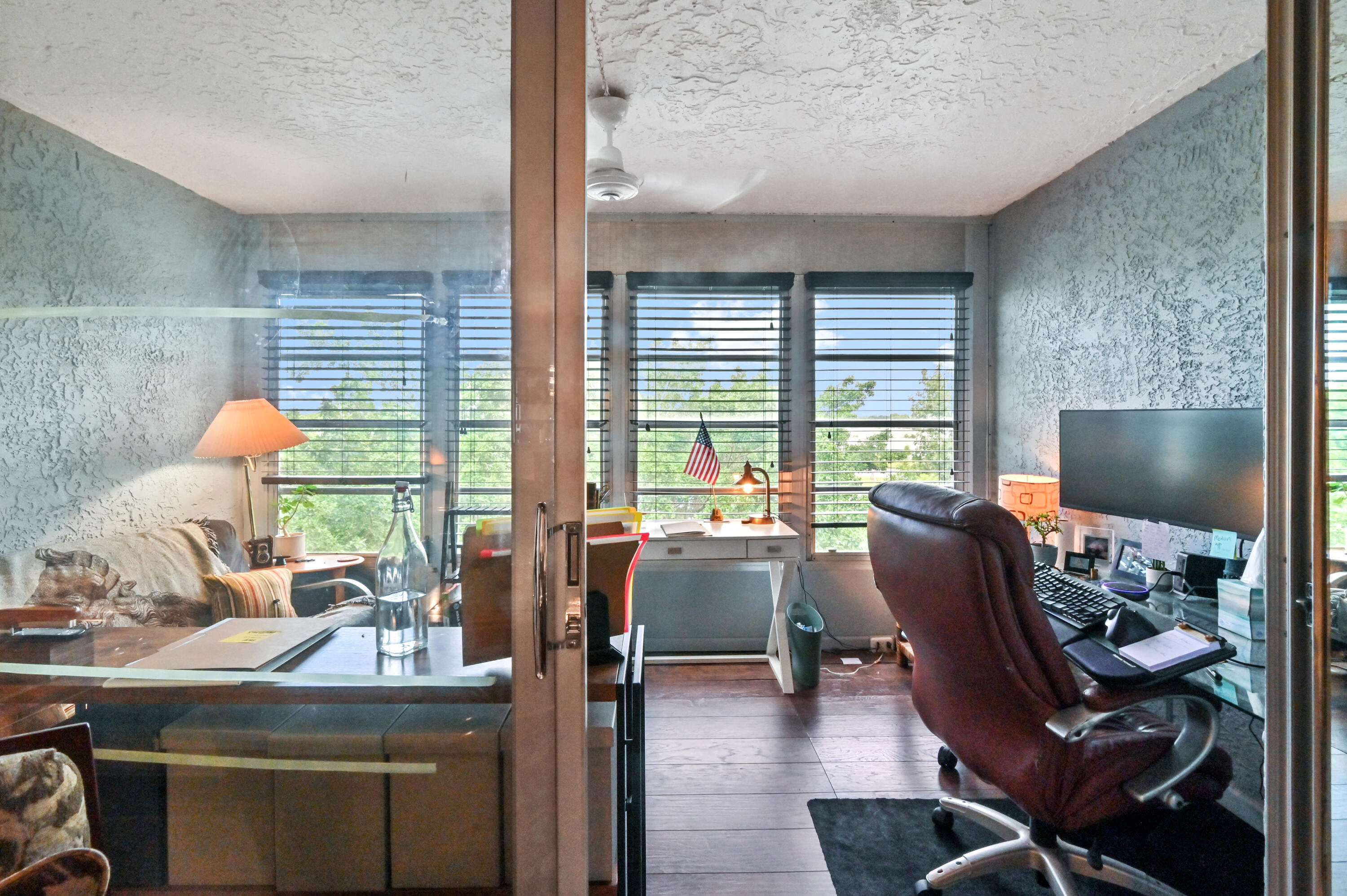 a work room with furniture and a large window