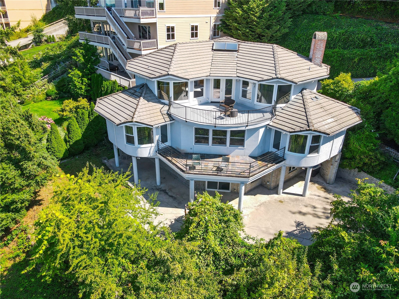 an aerial view of a house with a yard and sitting area