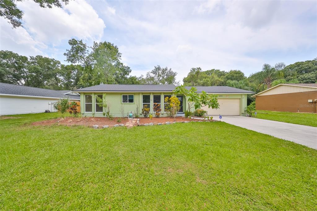 a front view of house with yard and green space