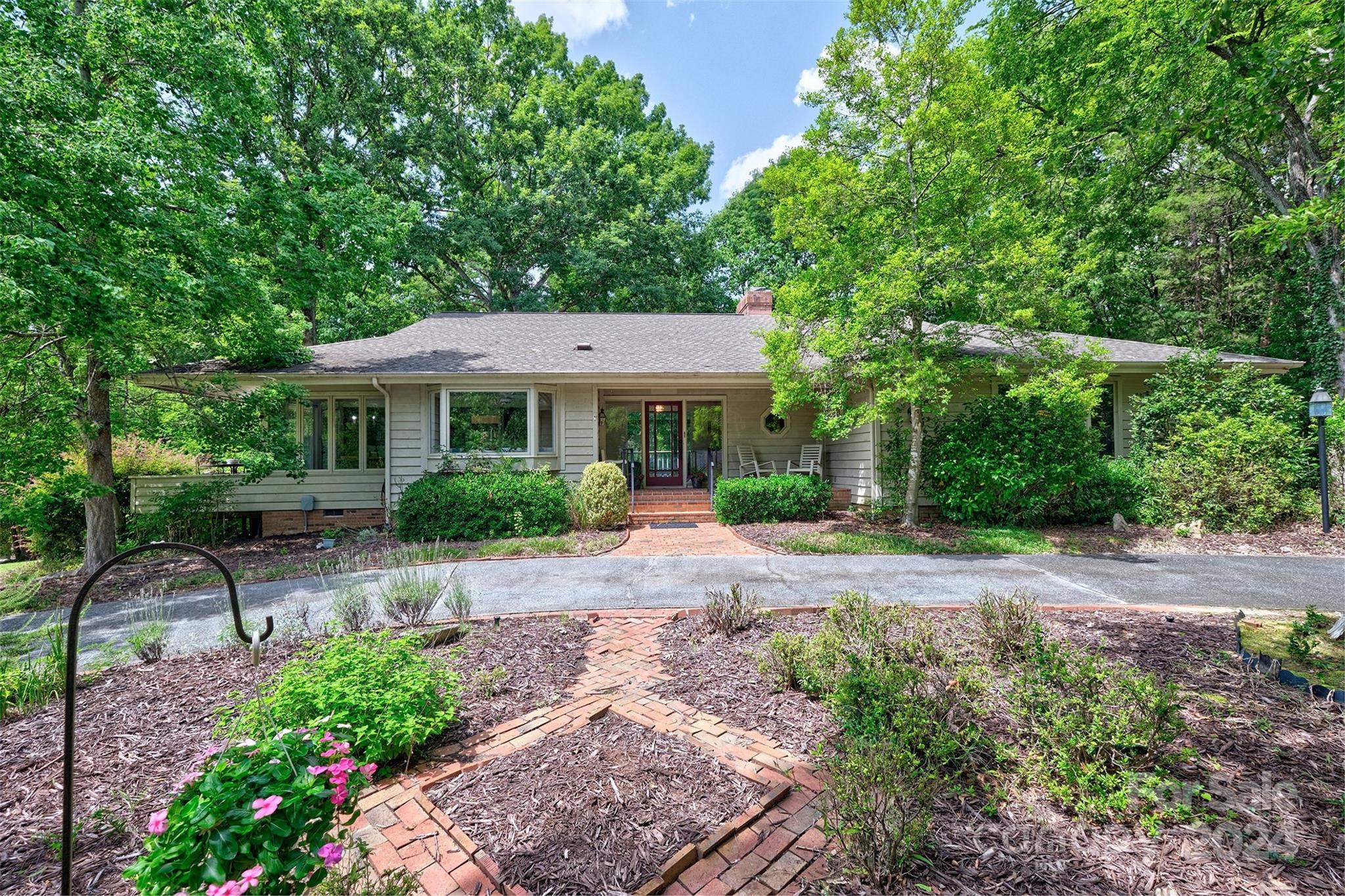 a front view of a house with a garden