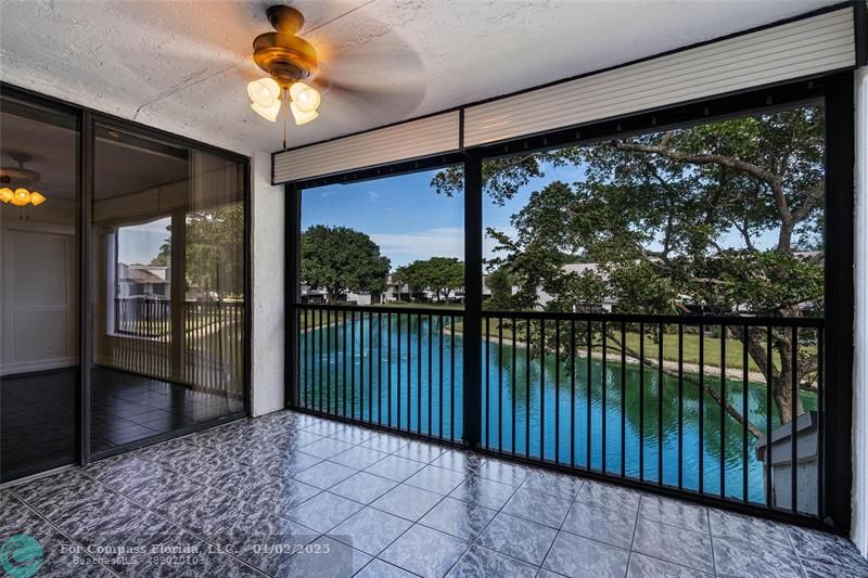 a view of a balcony with a floor to ceiling window and wooden floor