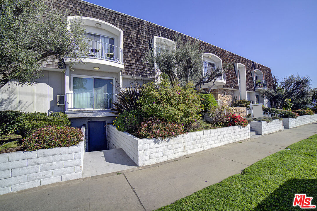 a view of a building with potted plants