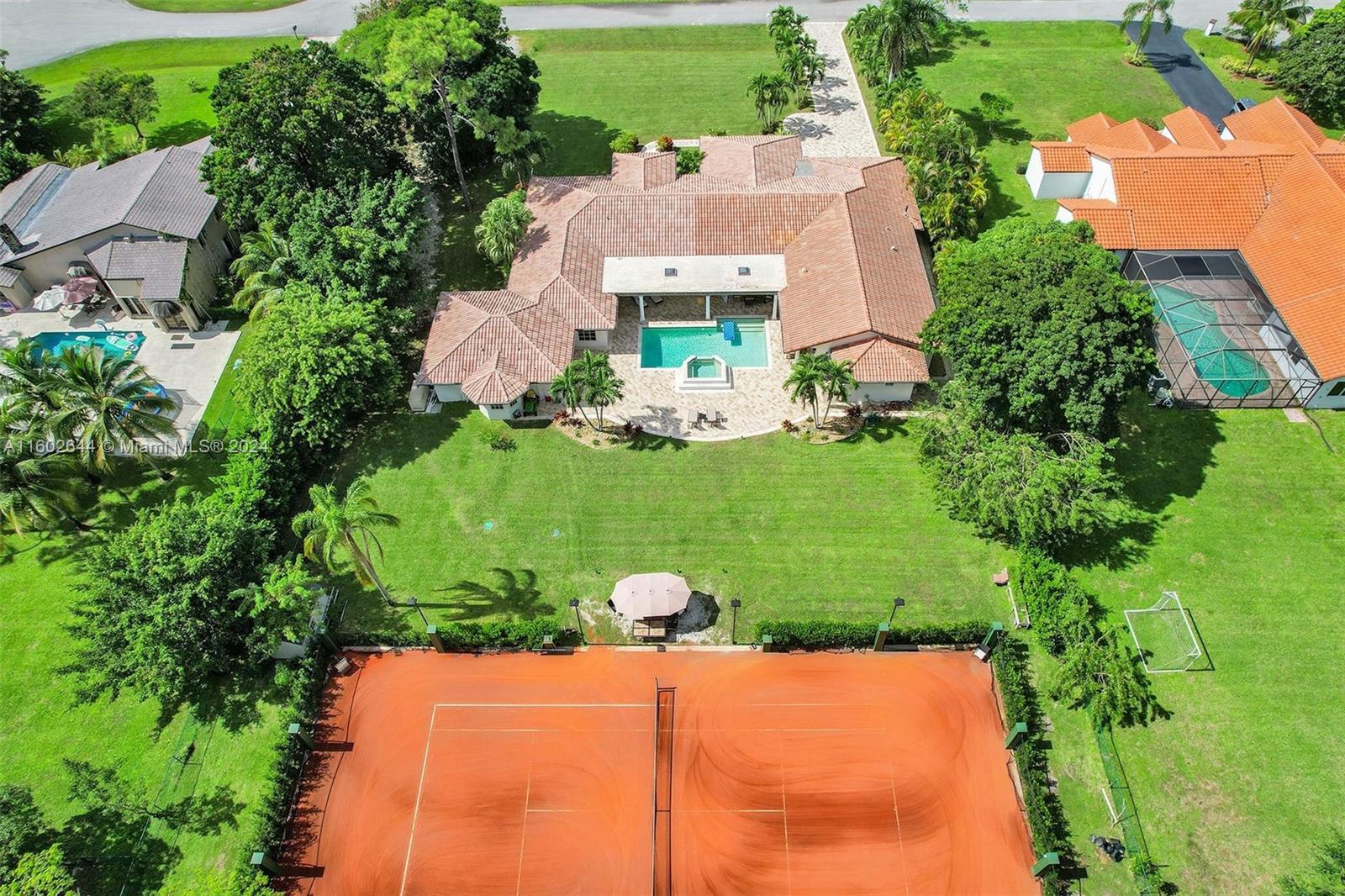 an aerial view of a house with a yard and lake view