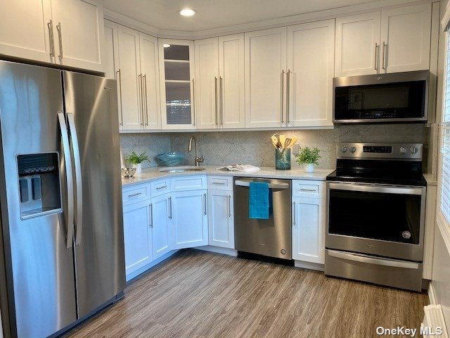 a kitchen with stainless steel appliances a stove a sink and a refrigerator