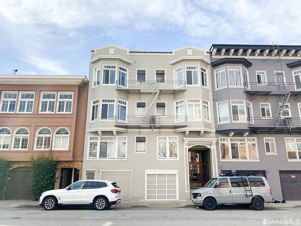 a car parked in front of a big building