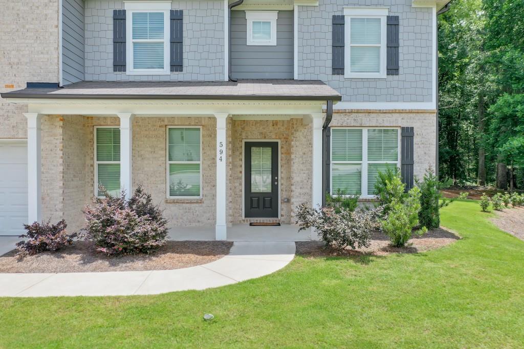 a front view of a house with a yard