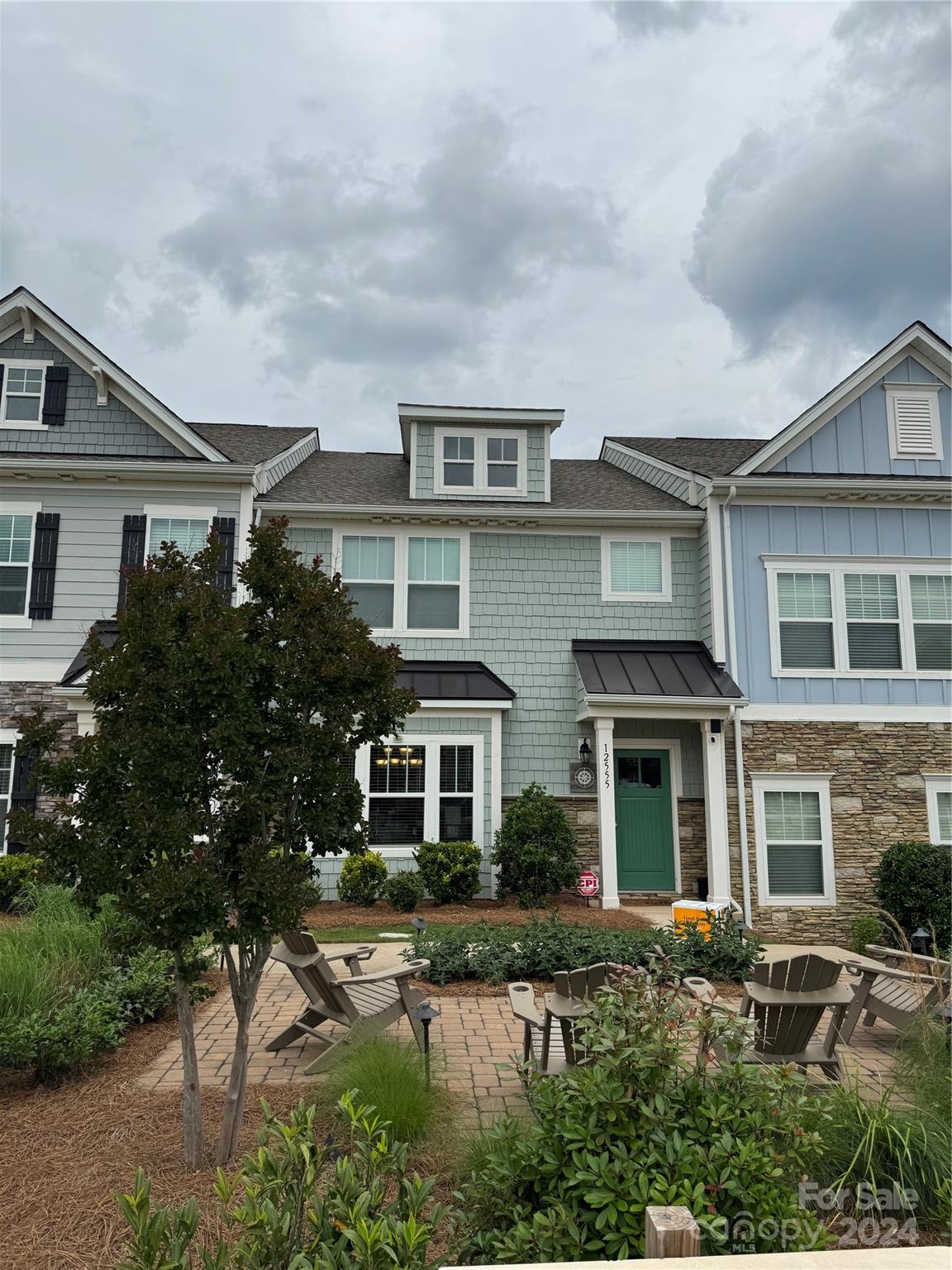 a front view of house with a yard and balcony